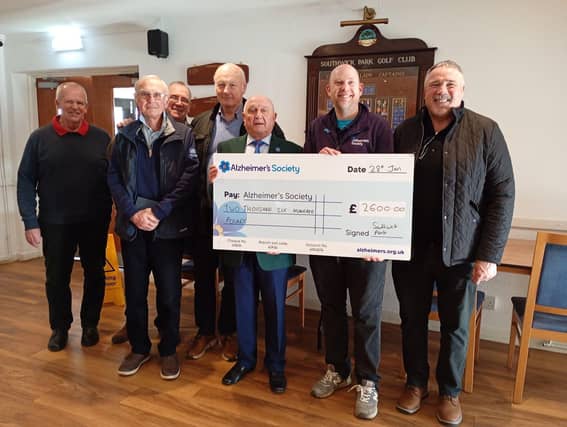 Captain Roy Valentine presenting his charity cheque to Ross Boon