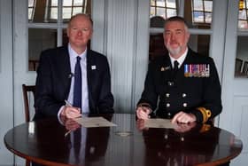 Neil Hayward, Chair of Hampshire and Isle of Wight Healthcare NHS Foundation Trust with Lieutenant Commander Steve Cass RN, Commanding Officer of HMS Victory, signing the Armed Forces Covenant aboard the HMS Victory in Portsmouth.