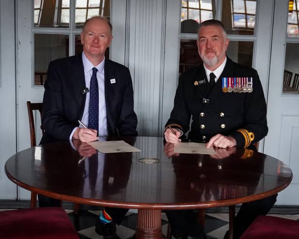 Neil Hayward, Chair of Hampshire and Isle of Wight Healthcare NHS Foundation Trust with Lieutenant Commander Steve Cass RN, Commanding Officer of HMS Victory, signing the Armed Forces Covenant aboard the HMS Victory in Portsmouth.
