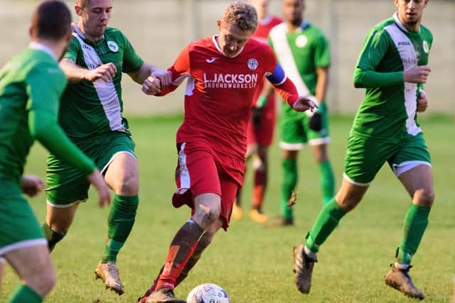 Horndean skipper Ash Howes (red) is unlikely to face Christchurch due to injury. Picture Credit: Keith Woodland