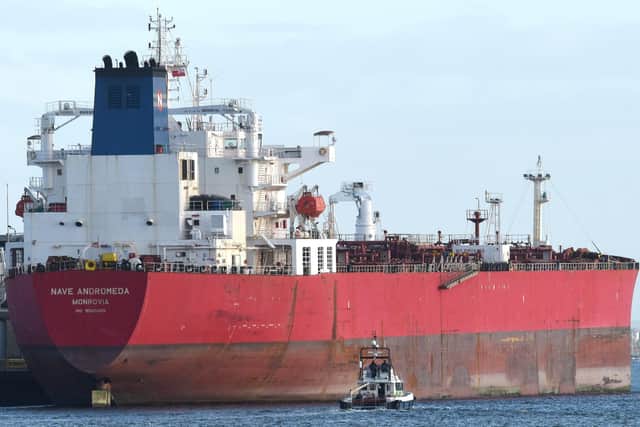 Pictured: A police boat patrolling next to the Nave Andromeda at berth in Port of Southampton this afternoon, following the major incident off the east coast of the Isle of Wight after seven stowaways were detained from the vessel after a reported hijacking. Photo: Simon Czapp/Solent News & Photo Agency