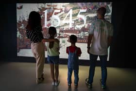 A family watches a preview of the new 1545 experience at The Mary Rose exhibition at Portsmouth Historic Dockyard. Picture: Andrew Matthews/PA Wire