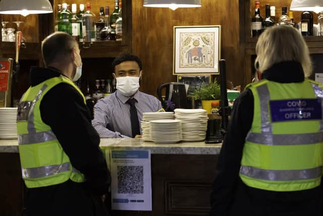Jafor Ahmed from the Akash restaurant in Southsea with Covid Business Compliance Officers