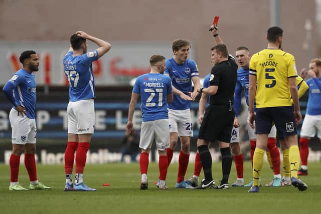 Sean Raggett leads the Pompey protests following Joe Morrell's 16th-minute sending off against Oxford United. Picture: Jason Brown/ProSportsImages