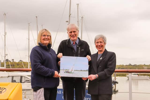 (l-r) Winner Maggie White with Lord Montagu and boat owner Joanne Husband with the print