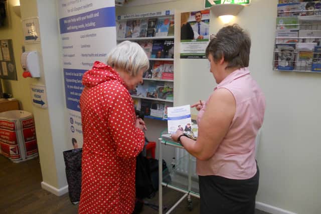 Angela Gill, Surgery Signposting project manager, giving information to a visitor to Bridgemary Medical Centre