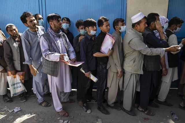 Afghans wait in long lines for hours at a passport office as many are desperate to flee the Taliban Picture: Paula Bronstein /Getty Images