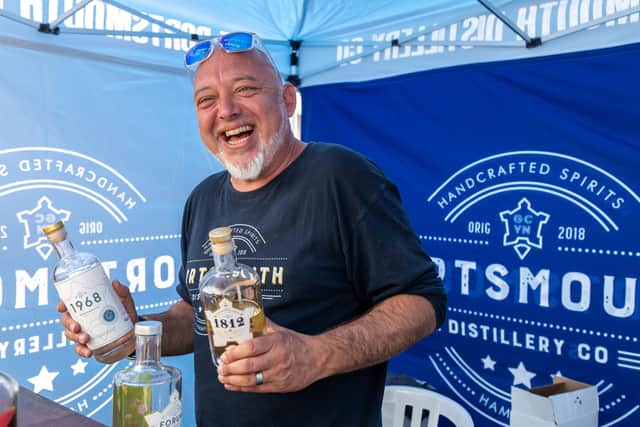 Dich Oatley from the Portsmouth Distillery gives out samples of the very first rum in English history to be made from scratch and aged 3 years. Picture: Mike Cooter (210522)