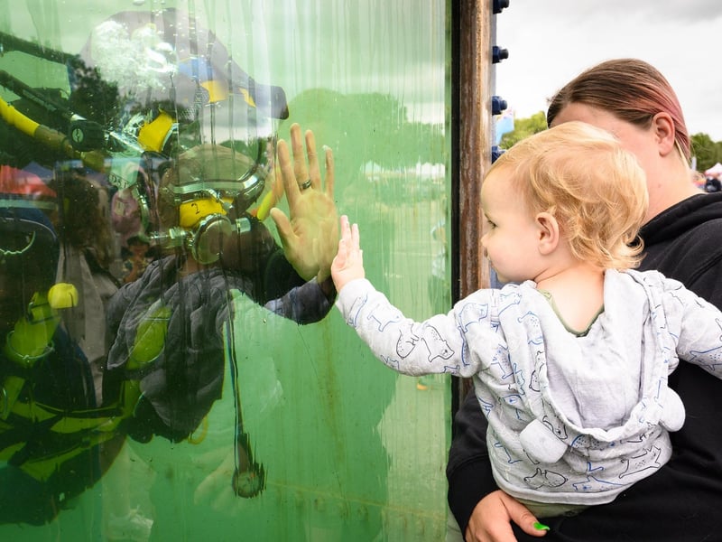 Alby Richards, 1, enjoys interacting with a diver.