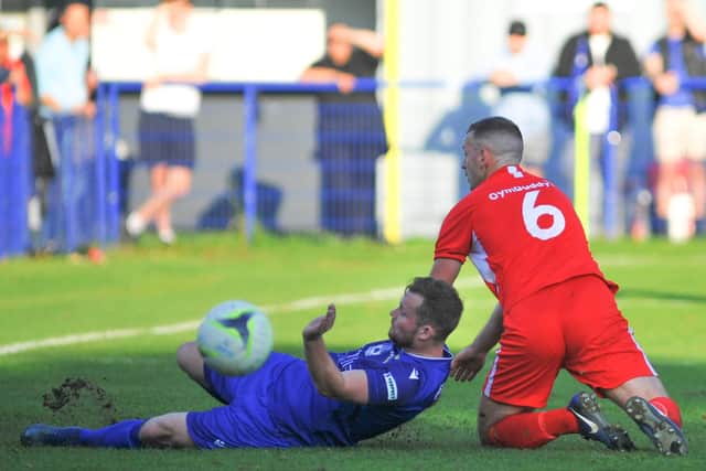 Baffins Milton Rovers' Miles Everett, left, goes to ground after a coming together with Horndean's Luke Dempsey. Picture: Martyn White