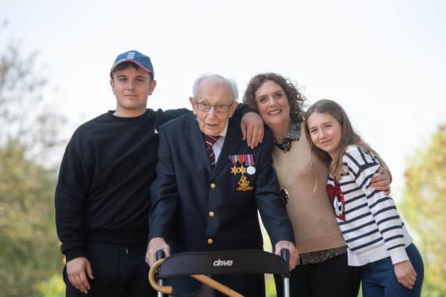 Captain Sir Tom Moore, with (left to right) grandson Benji, daughter Hannah Ingram-Moore and granddaughter Georgia, at his home in Marston Moretaine, Bedfordshire, after he achieved his goal of 100 laps of his garden. Picture: Joe Giddens/PA Wire