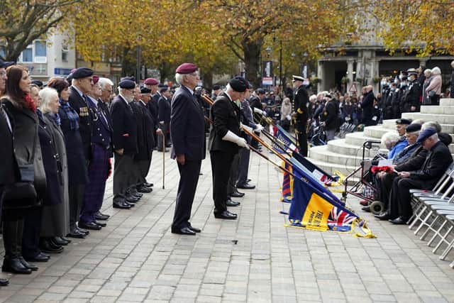 Standard bearers lower their standards during the Remembrance Service at the Guildhall Square, in Portsmouth. Picture date: Sunday November 14, 2021.
