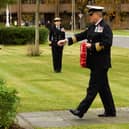 Commander Mark Walker places a wreath at the Falkland Islands memorial stone.