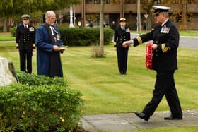 Commander Mark Walker places a wreath at the Falkland Islands memorial stone.