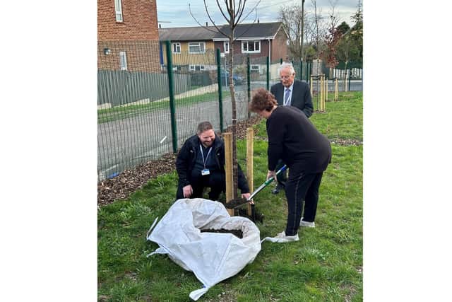 Jim Patey plants a tree with resident Sue at Patey Court in Paulsgrove, Portsmouth, which provides assisted living for 28 adults with learning disabilities