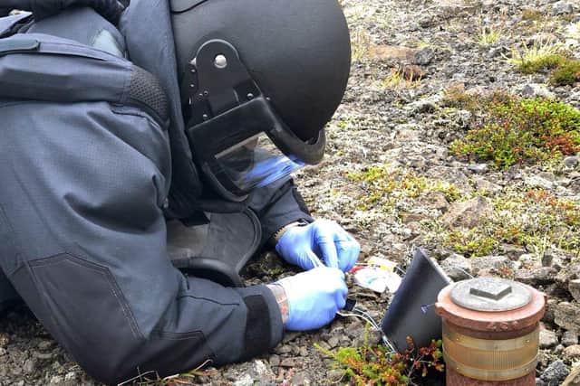 A Royal Navy diver from Portsmouth practises dealing with improvised explosive devices on land. Photo: Royal Navy