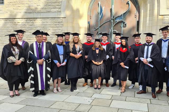 Happy students and staff at City of Portsmouth Colleges graduation ceremony.