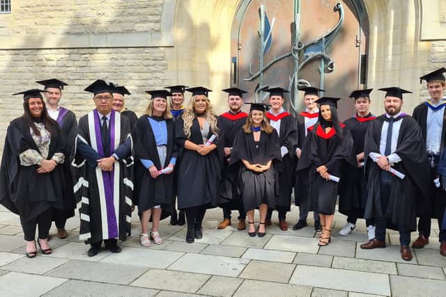 Happy students and staff at City of Portsmouth Colleges graduation ceremony.