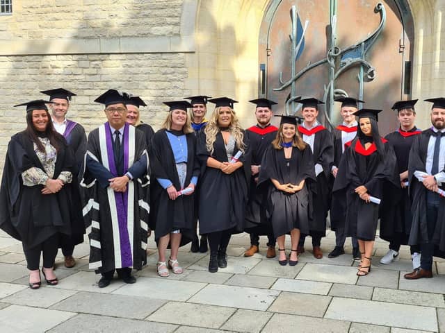 Happy students and staff at City of Portsmouth Colleges graduation ceremony.