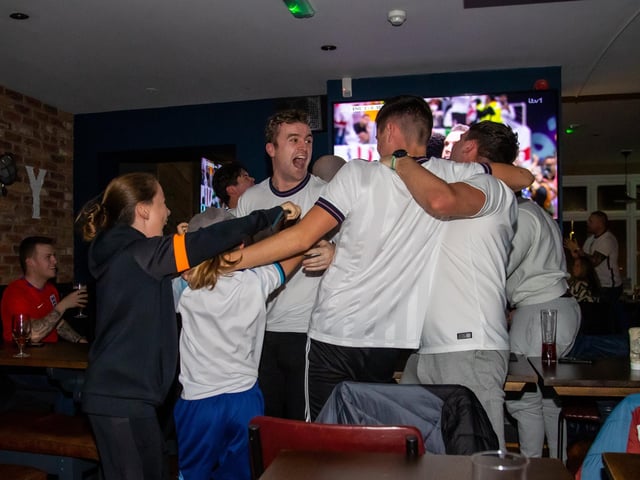 Fans celebrate England scoring against Senegal. Photos by Alex Shute
