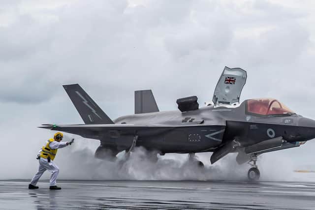 An aircraft handler directs take off of F35 from HMS Queen Elizabeth. Photo: Royal Navy