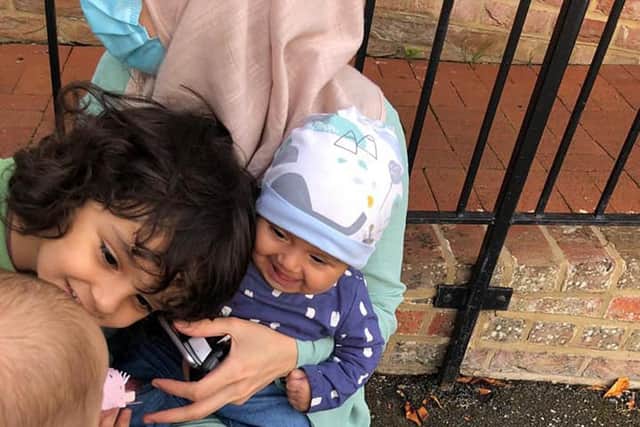 Four-month-old Barney Kenchington (left) and his brother Archer, six, looking at Afghan refugees four-month old, Madiha (second right) and her brother Wais. Picture: Matt Simmons/PA Wire