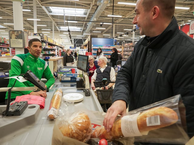 David James on the checkouts with shopper Ian Carter. Former England and Portmouth goalkeeper, David James launched Football Rebooted at Tesco, Fratton Way, Portsmouth. Utilita an Pompey in The Community have brought Football Rebooted to the city. It's a boot collection box where football boots can be donated and redistributed to another player. Picture: Chris Moorhouse (180125-13)