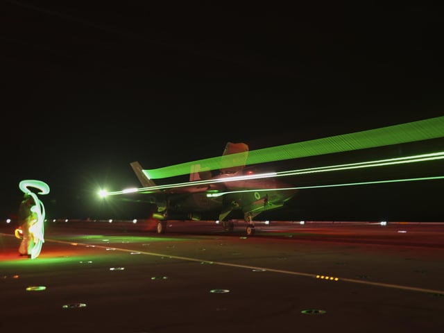 A long exposure of a F35-B jet of 617 Squadron conducting night flying as they continue Carrier Qualifications on board HMS Queen Elizabeth.