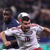Gibraltar midfielder Liam Walker - a former Pompey player - challenges Dayot Upamecano in a 14-0 victory for France. Picture: FRANCK FIFE/AFP via Getty Images.