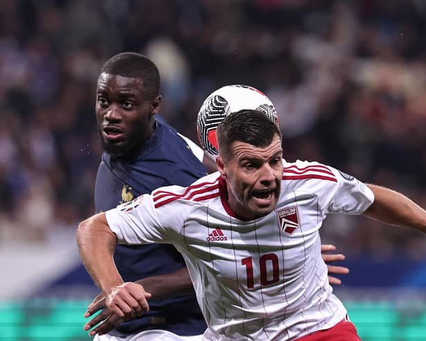 Gibraltar midfielder Liam Walker - a former Pompey player - challenges Dayot Upamecano in a 14-0 victory for France. Picture: FRANCK FIFE/AFP via Getty Images.