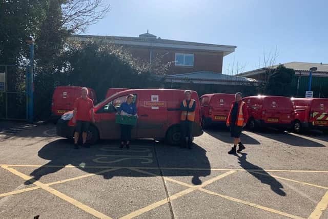 Growing Places staff member Adele Tindall-Barber giving a hamper to Royal mail workers