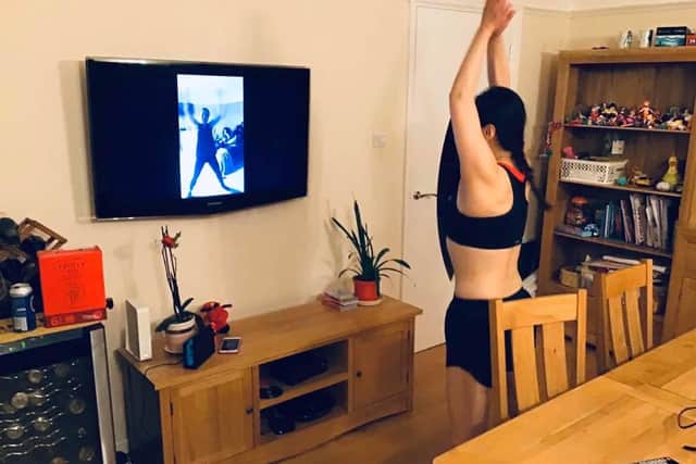 Amy Dong completes her workout from home with Jo Mitchell on screen 