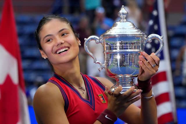Emma Raducanu celebrates with the trophy after winning the 2021 US Open. Photo by TIMOTHY A. CLARY/AFP via Getty Images.