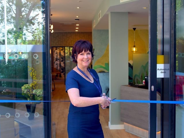 Julie Fisher, Centre Manager at Langstone Gate, cuts the ribbon to officially open the centre.