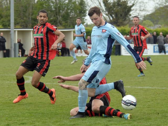 Joe Noakes (blue) made a remarkable playing comeback for Portchester against AFC Totton. Picture: Mick Young