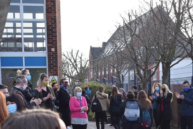 Priory School staff form a guard of honour for returning Year 11 pupils.