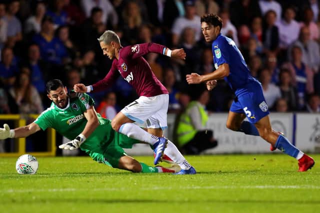 West Ham's Javier Hernandez attempts to take the ball around Tom King in Carabao Cup match in August 2018. King was on loan with AFC Wimbledon at the time. Picture: Catherine Ivill/Getty Images