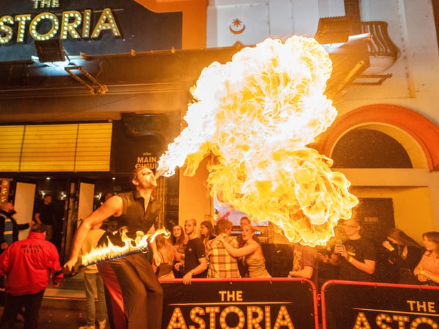 Fire Dan, beating fire outside The Astoria for Freshers Week 2022. Photo by Matt Clark