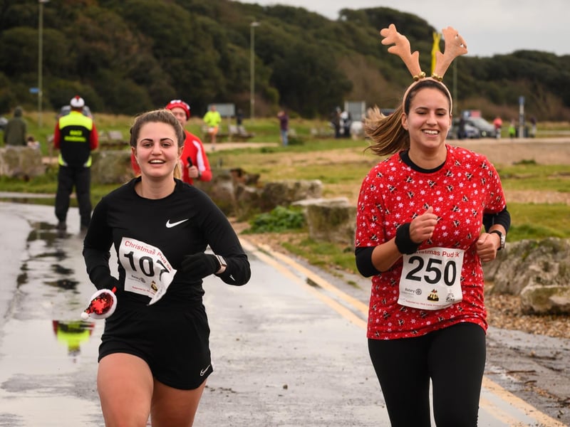 Its all smiles at the finish line for two runners at the Christmas Pud 5k, Stokes Bay, Gosport