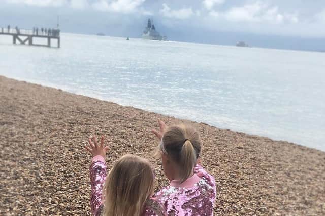 Jessica and Ella Hulks, aged eight and five, wave off their dad from Portsmouth. This image features as part of the 2021 Little Troopers calendar.
