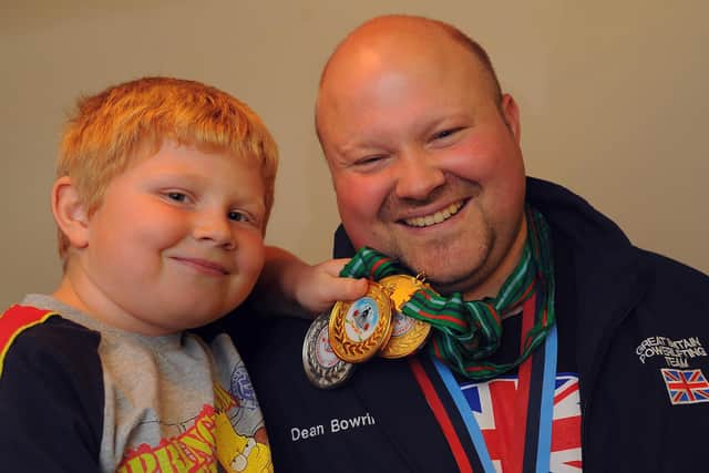 Flashback - Dean Bowring after winning the Super Heavyweight title at the World Powerlifting Championships in India in November 2009. Son Ray, then seven, is also in the picture. Picture: Malcolm Wells.