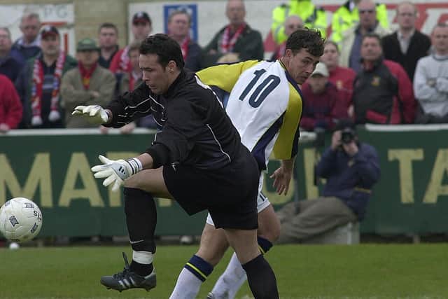 James Taylor tangles with Tamworth goalkeeper Darren Acton during Hawks' FA Trophy semi-final second leg in 2003.