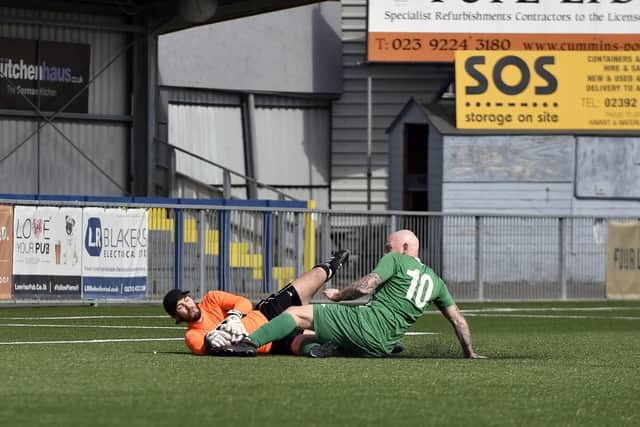 Mob Albion striker Andy Brown slides in to challenge Burrfields keeper Dwayne Gray. Picture: Allan Hutchings