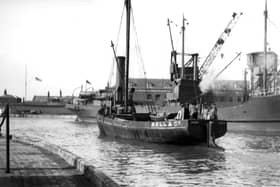 A long gone scene at the Camber, Old Portsmouth.
With a collier tied up alongside the Camber dock we see a steam vessel making her way out to the harbour. Picture: Barry Cox collection