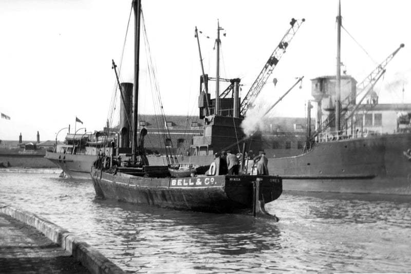 A long gone scene at the Camber, Old Portsmouth.
With a collier tied up alongside the Camber dock we see a steam vessel making her way out to the harbour. Picture: Barry Cox collection