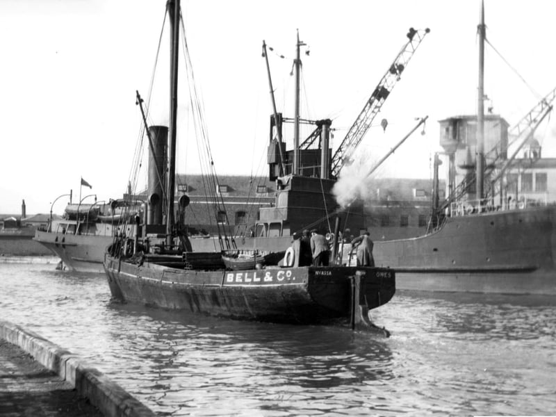 A long gone scene at the Camber, Old Portsmouth.
With a collier tied up alongside the Camber dock we see a steam vessel making her way out to the harbour. Picture: Barry Cox collection