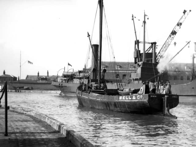A long gone scene at the Camber, Old Portsmouth.
With a collier tied up alongside the Camber dock we see a steam vessel making her way out to the harbour. Picture: Barry Cox collection