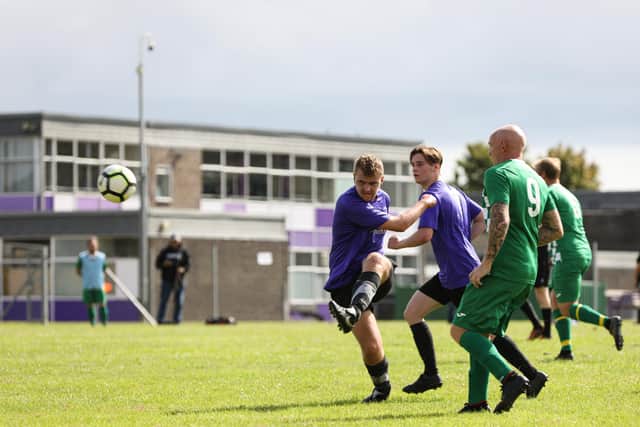 Sam Robinson clears for East Lodge during their 2-0 loss to Mob Albion. Picture: Chris Moorhouse