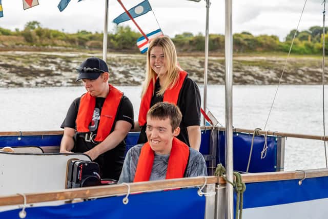 Billy Predith and Rowan Hayward with their carer Poppy Edwards (18) during their boat trip on the Rebecca Anne. Picture: Mike Cooter (200822)