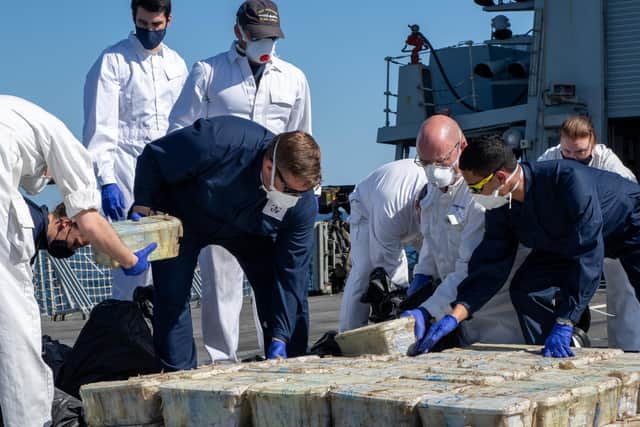 Who: (L-R) SLt Carter, LH Aston, Lt Graham, CPO Warren, Lt Cdr Wheldon,
WO1 Ronaldson, CPO Jacobs, PO (P) Hunn
What: Seized drugs being mustered and catalogued
Why: To record types and weights of each drug
Where: Gulf of Oman
When: 24 January 2022
Photographer: CPO AWW Jones-Price